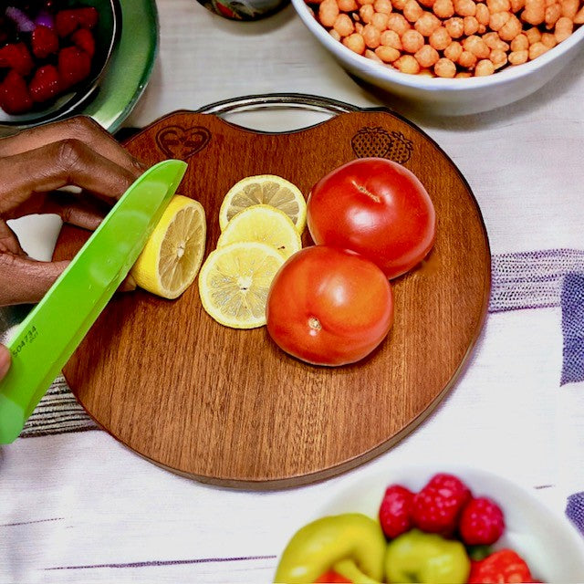 Fervor4Flavor's Ebony Wood Round Cutting Board with Stainless Steel Handle: Stylishly versatile. Perfect for cheeses, meats, crackers, and wine.
